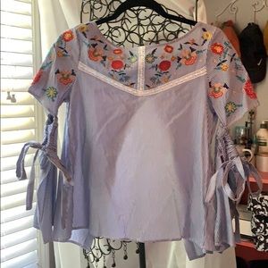 Floral accented blouse with attached sleeves